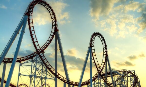 A roller coaster with two loop-de-loops against a late-afternoon sky