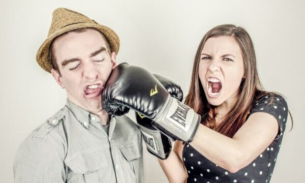 woman with boxing gloves punching man