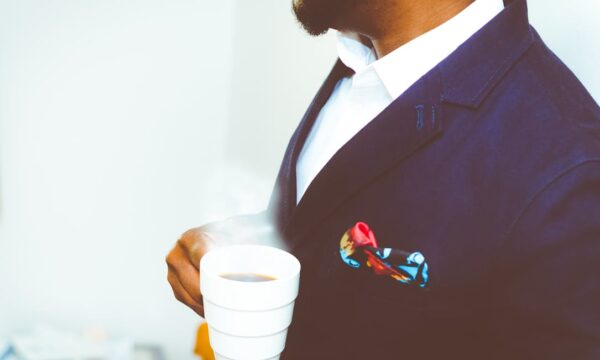 man in suit with coffee