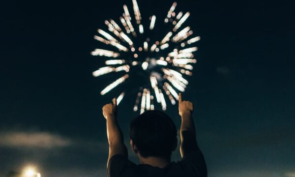 man pointing at fireworks