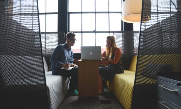 man and woman working in lounge