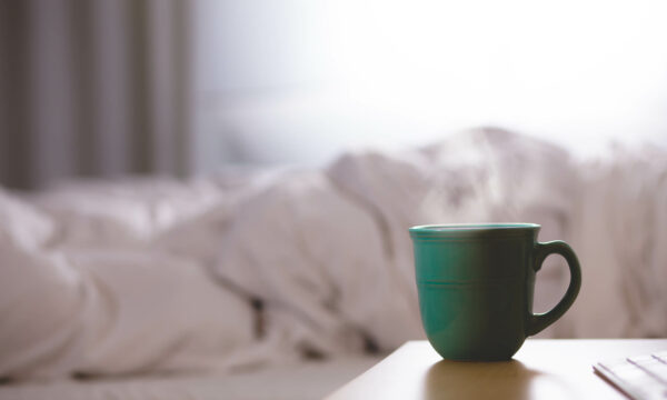 coffee cup next to bed
