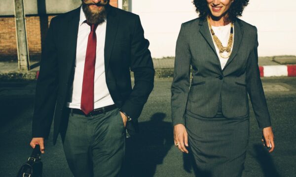 man and women in business suits walking