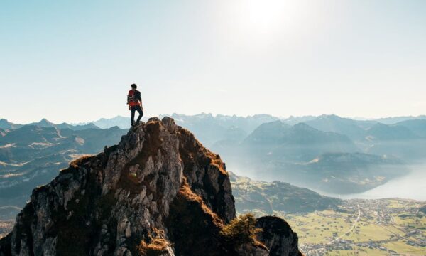 man at top of mountain