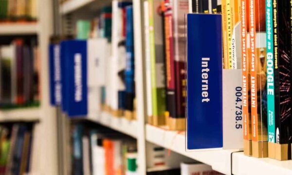 books on bookshelf with internet tag in foreground