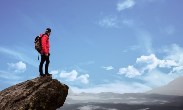 man at top of mountain