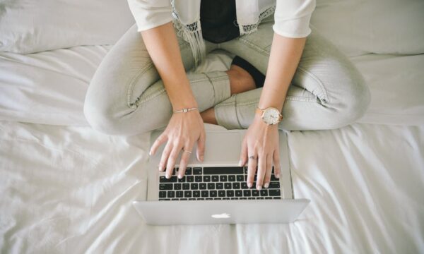 woman on laptop in bed