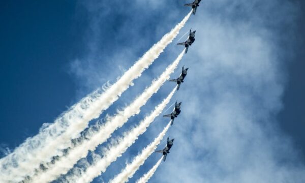 fighter jets flying in line with smoke