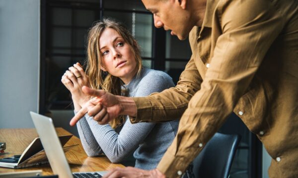 woman and man talking at desk