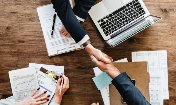 shaking hands over table