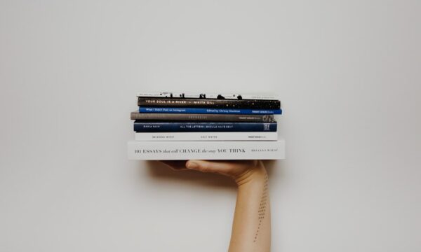 stack of books in hand