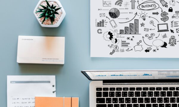 papers and laptop on desk