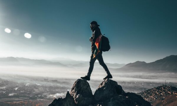 person at top of mountain