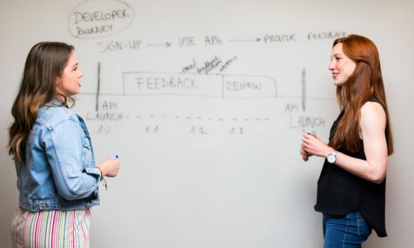 two women at white board